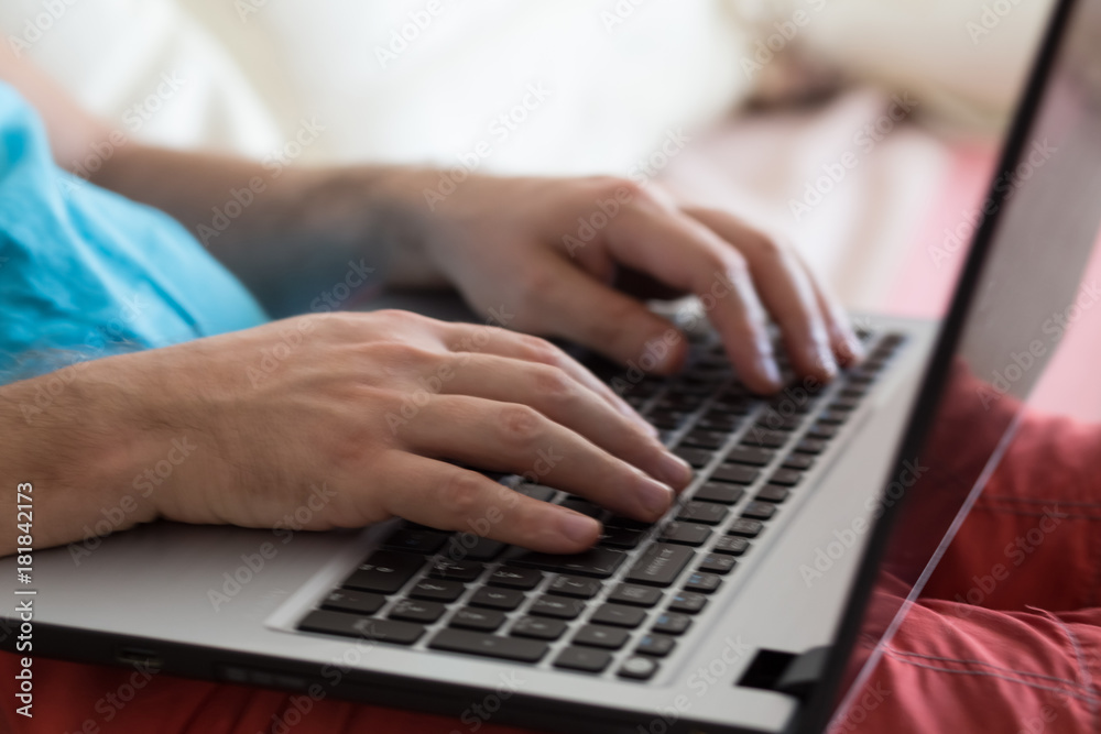 Man's hands typing on laptop notebook keyboard at home. Man browsing information on internet. Freelance blogging, it support concept. Man's hands typing on laptop notebook keyboard at home. Man browsing information on internet. Freelance blogging, it support concept.