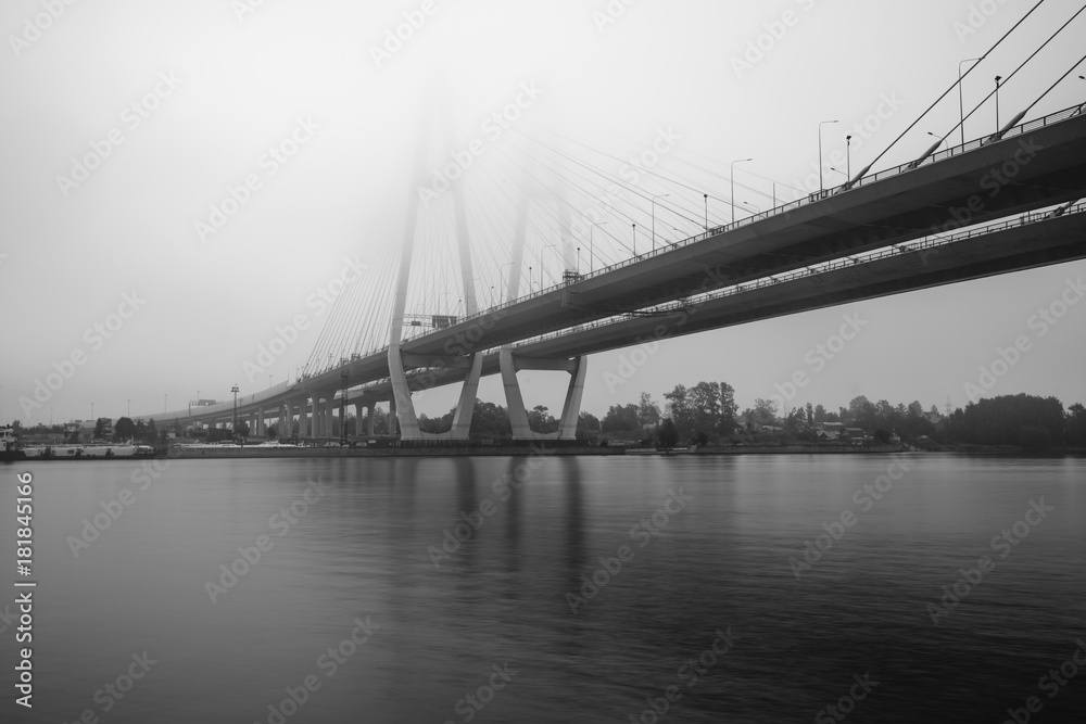 Cable-stayed bridge in Saint Petersburg. Bridge over Neva river in Saint-Petersburg, Russia. Fog night city.