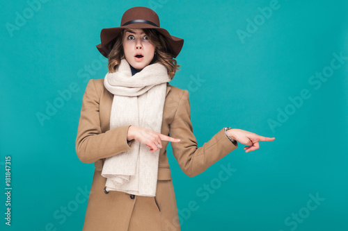 Amazement woman pointing finger at copy space with shocked face. photo