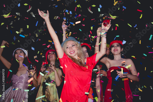 Cheerful Party - Woman Enjoy Dancing and Drinking with Friends in Nightclub with Colorful Laser and Confetti