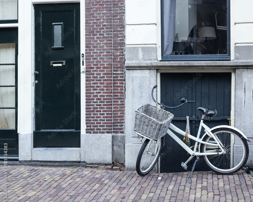Bicycles and flowers in Amsterdam Holland Netherlands near famous UNESCO world heritage canals Singel with typical dutch houseboats