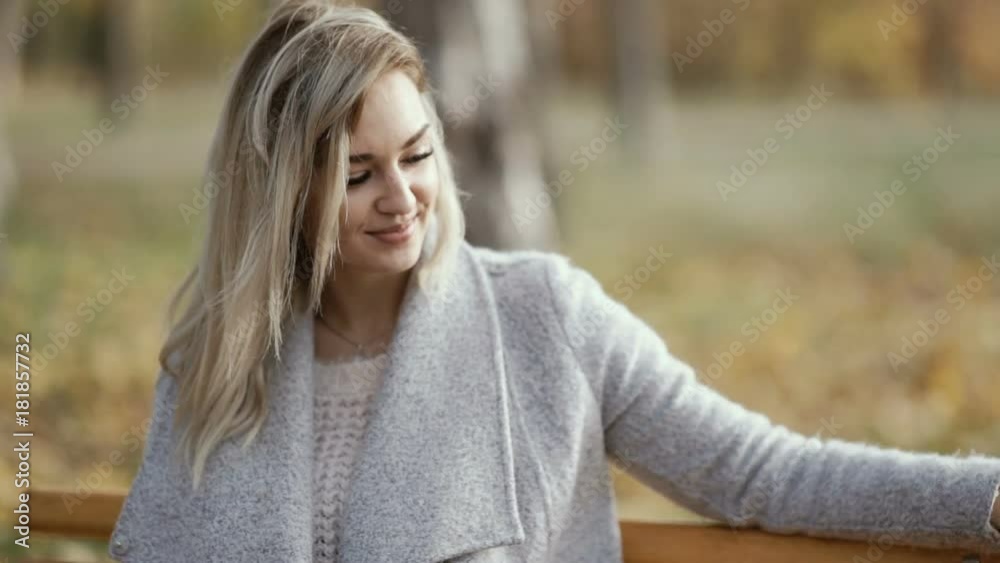Portrait of Attractive Smiling Caucasian Woman in park. Autumn background Portrait of Attractive Smiling Caucasian Woman in park. Autumn background