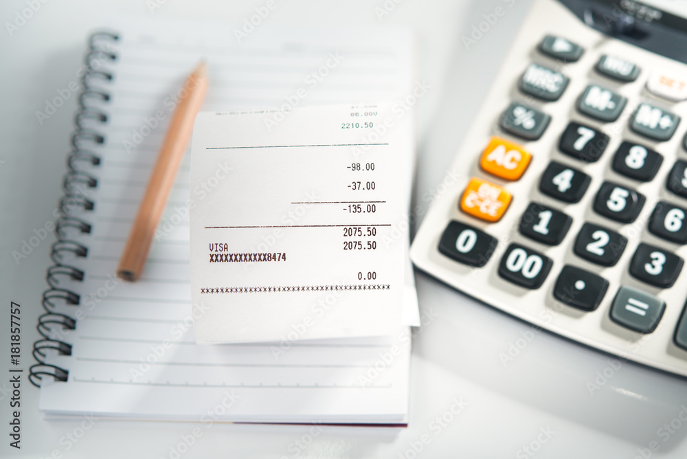 Grocery shopping list on notebook with calculator and pencil - money account management concept Grocery shopping list on notebook with calculator and pencil - money account management concept