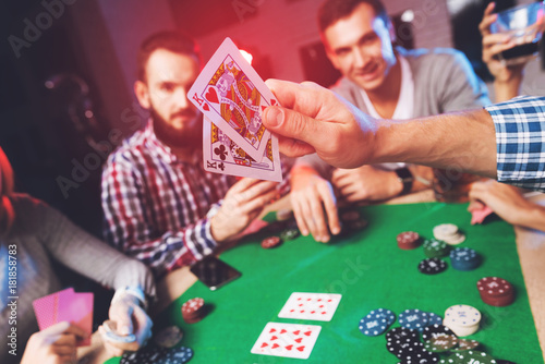 Young people play poker at the table. photo