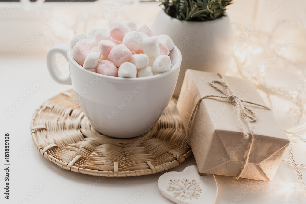 Cup of hot chocolate and marshmallow in the background of Christmas decorations. Cup of hot chocolate and marshmallow in the background of Christmas decorations.