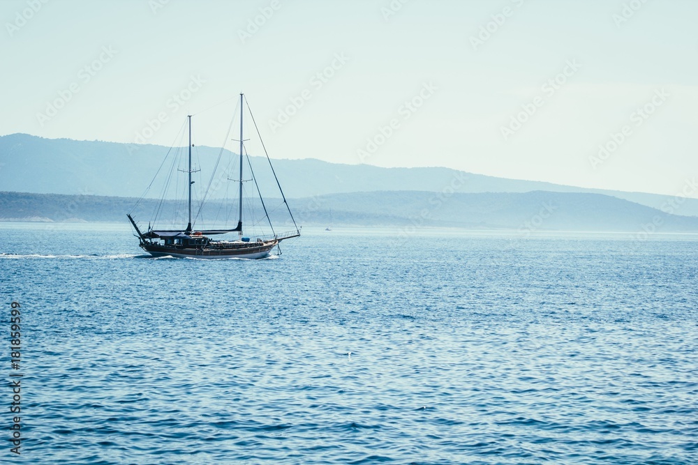 Fototapeta premium Sailboat on blue sea background