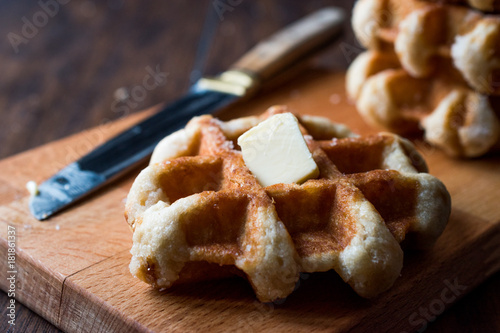 Belgium Waffle with Butter on wooden surface.