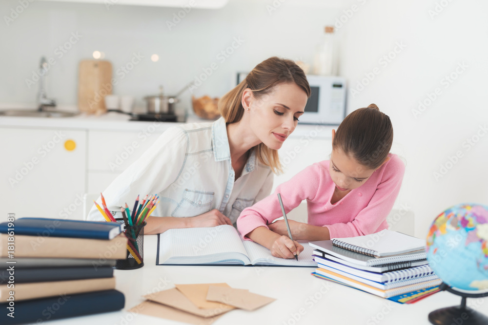 Mom helps my daughter do her homework in the kitchen. Mom helps my daughter do her homework in the kitchen.