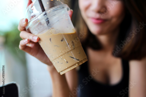 Portrait of smiling beautiful woman drinking cold coffee