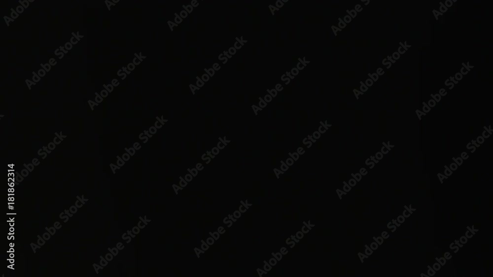 Water dripping against a black background. Close-up shot Water dripping against a black background. Close-up shot