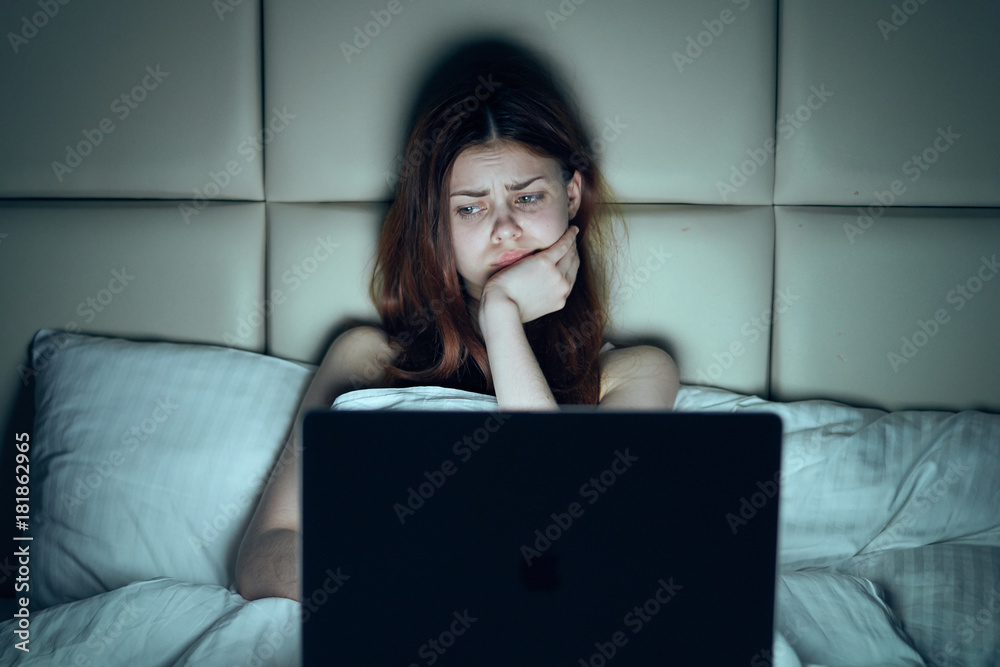 Fototapeta premium Beautiful young woman working at computer at home