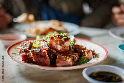 Thai roasted pork with sauce on table with shallow dept of field scene