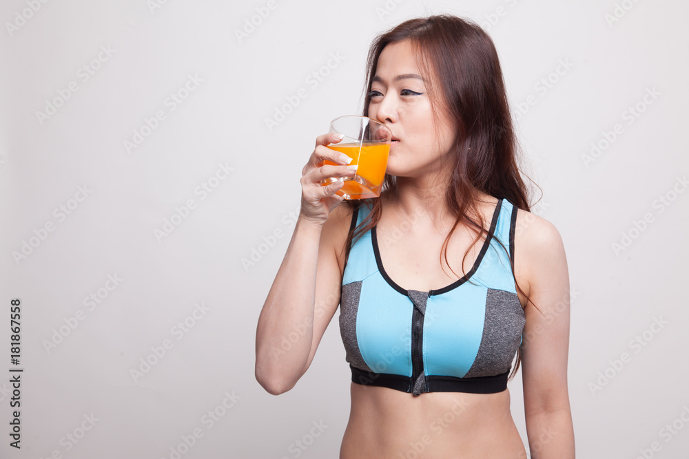 Beautiful Asian healthy girl drinking orange juice. Beautiful Asian healthy girl drinking orange juice.
