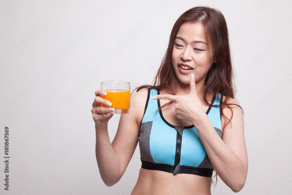 Beautiful Asian healthy girl point to orange juice. Beautiful Asian healthy girl point to orange juice.