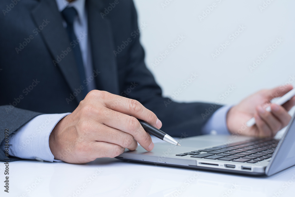 Businessman working on laptop computer and mobile smart phone Businessman working on laptop computer and mobile smart phone
