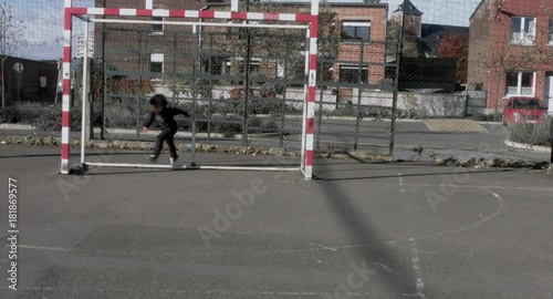 Wallpaper Mural Cute little African American black kid playing with soccer ball in the field, urban background. 4K UHD Torontodigital.ca
