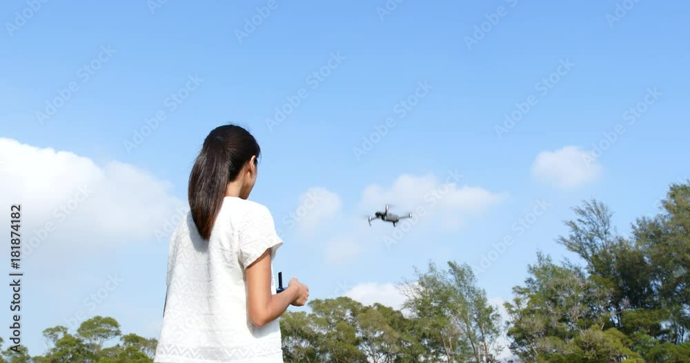 Woman control fly drone with blue sky at outdoor Woman control fly drone with blue sky at outdoor