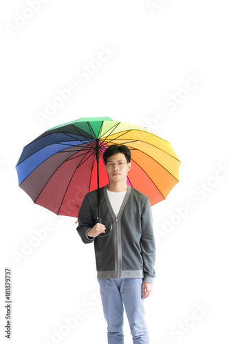 Portrait of young man with rainbow hat umbrella isolated on white.