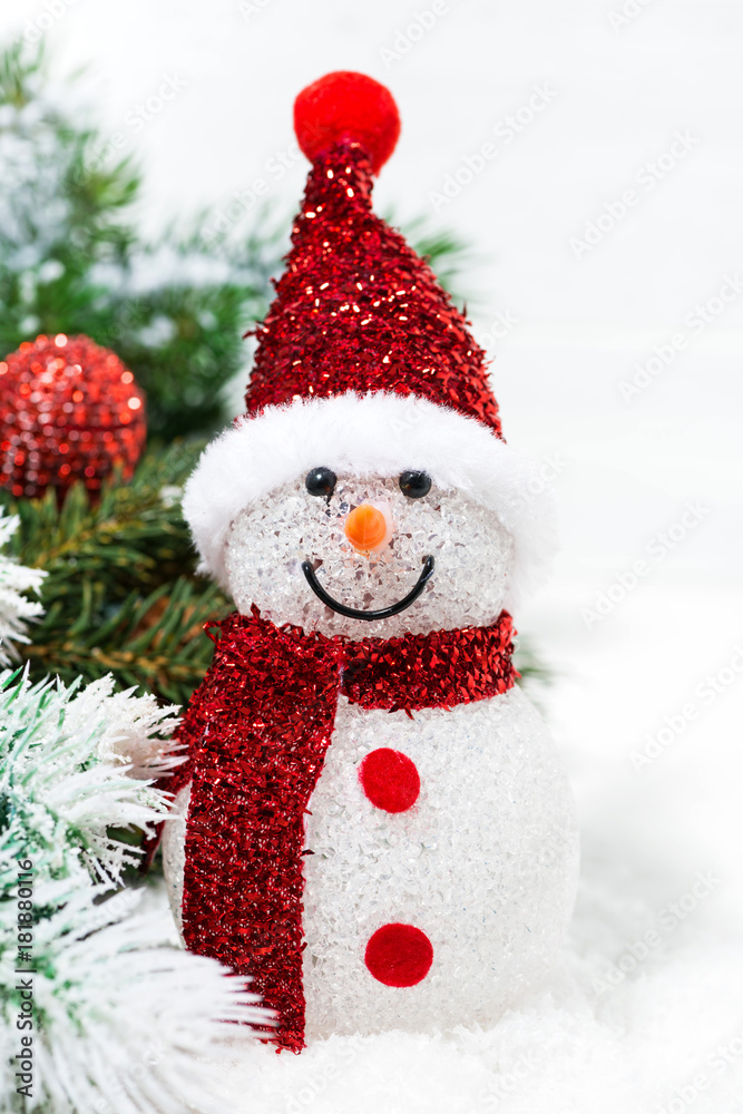 christmas snowman in fir branches on a white background, closeup