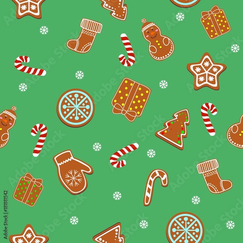 Beautiful Christmas ginger cookies, ginger cookies and candies on a green background. Seamless texture background.