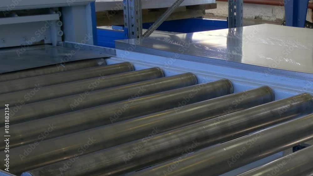 Cutting holes of metal sheets on industrial CNC machine. Automation of work. Refrigeration and ventilation equipment and air conditioners. Modern technologies.