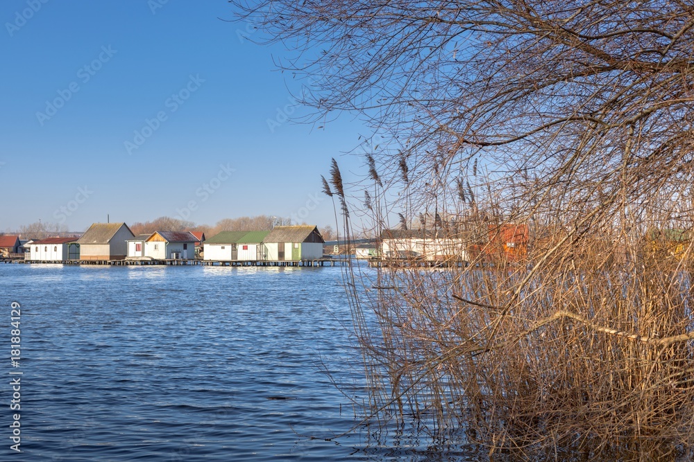 Fototapeta premium Wooden house on the lake at winter