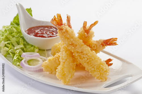Tempura Jumbo Shrimps with salad and salsa dip on white plate and white background