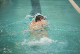 Senior man swimming in freestyle - Concept of sport and fun in swimming pool
