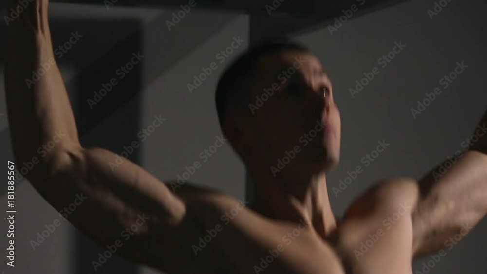 rolled man performs pull-UPS closeup in the gym. You can see all the muscles. rolled man performs pull-UPS closeup in the gym. You can see all the muscles.