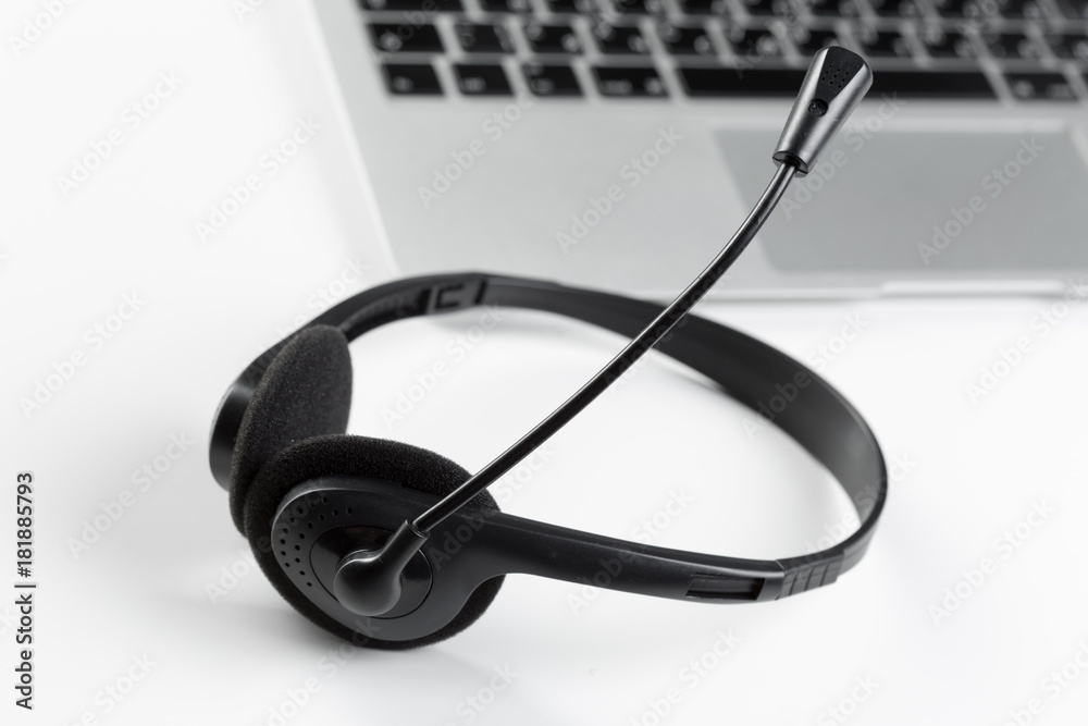 call center support concept. headset on keyboard computer laptop call center support concept. headset on keyboard computer laptop
