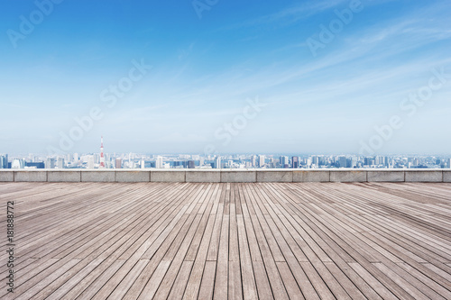 empty wooden floor with modern cityscape