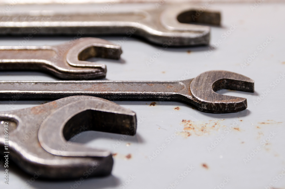 several wrenches on the background of metal plates several wrenches on the background of metal plates