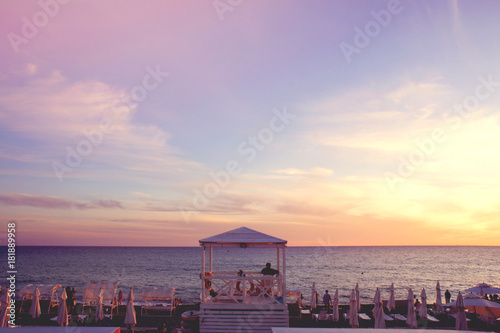 Lifeguard booth at the evening beach. Beautiful evening sea horizon at sunset