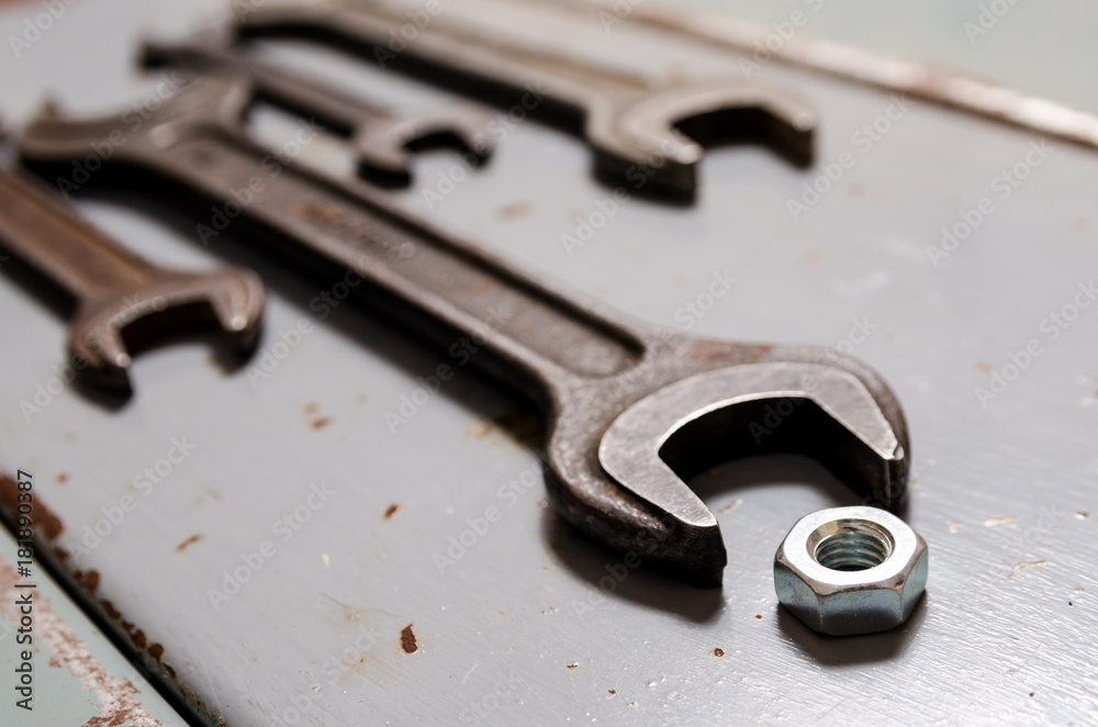 several wrenches and screw-nut on the metal background several wrenches and screw-nut on the metal background