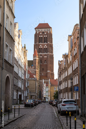 View of old buildings on the Zlotnikow Street and St. Mary's Church at the Main Town (Old Town) in Gdansk, Poland, on a sunny day.