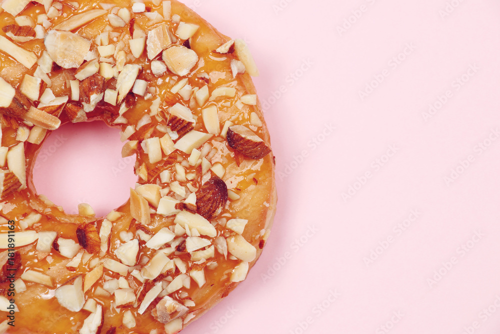Delicious donut with almond caramel glazed, Isolated on pink background. Delicious donut with almond caramel glazed, Isolated on pink background.