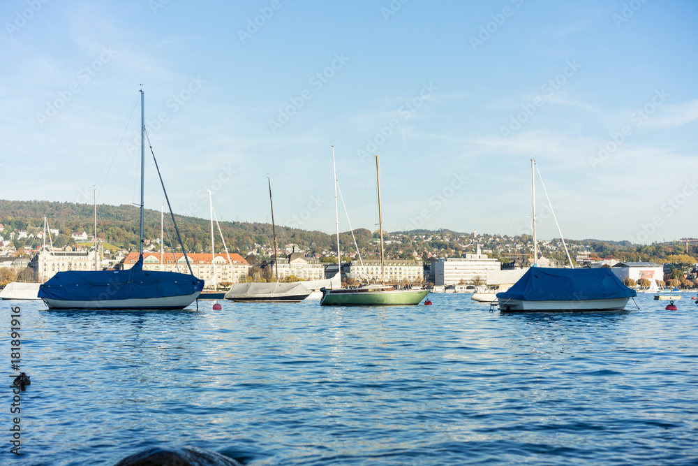 boats on lake zurich in summer with city background