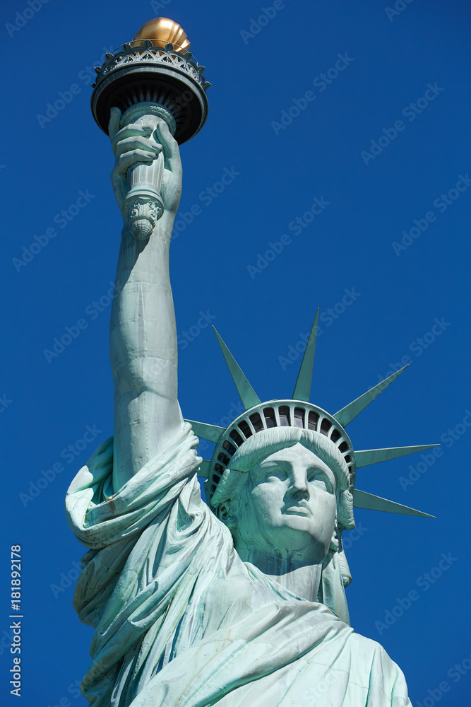 Fototapeta premium Statue of Liberty upper part in a sunny day, blue sky in New York