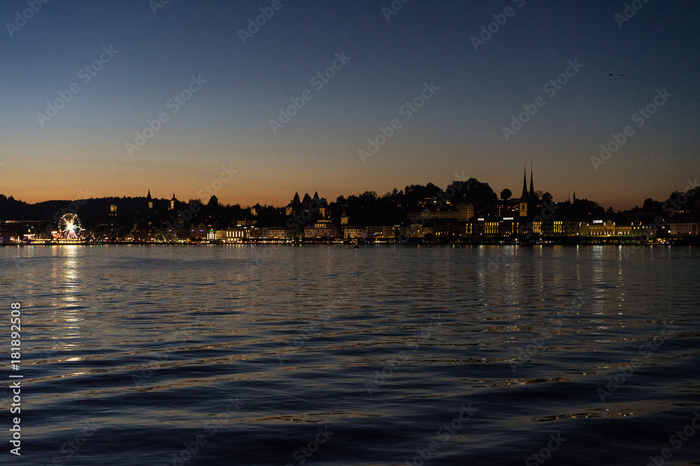sunset on lake lucerne viewed from boat with city background sunset on lake lucerne viewed from boat with city background