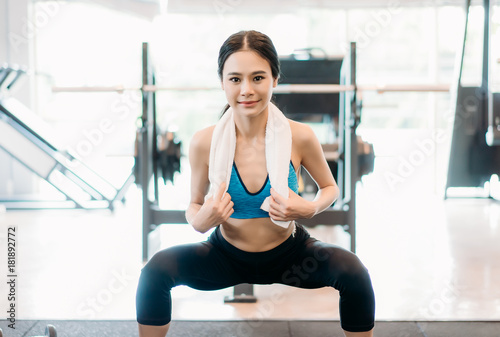 Sports girl with sportswear doing squats on platform in gym ,Fitness Concept,Healthy Lifestyle and people concept.