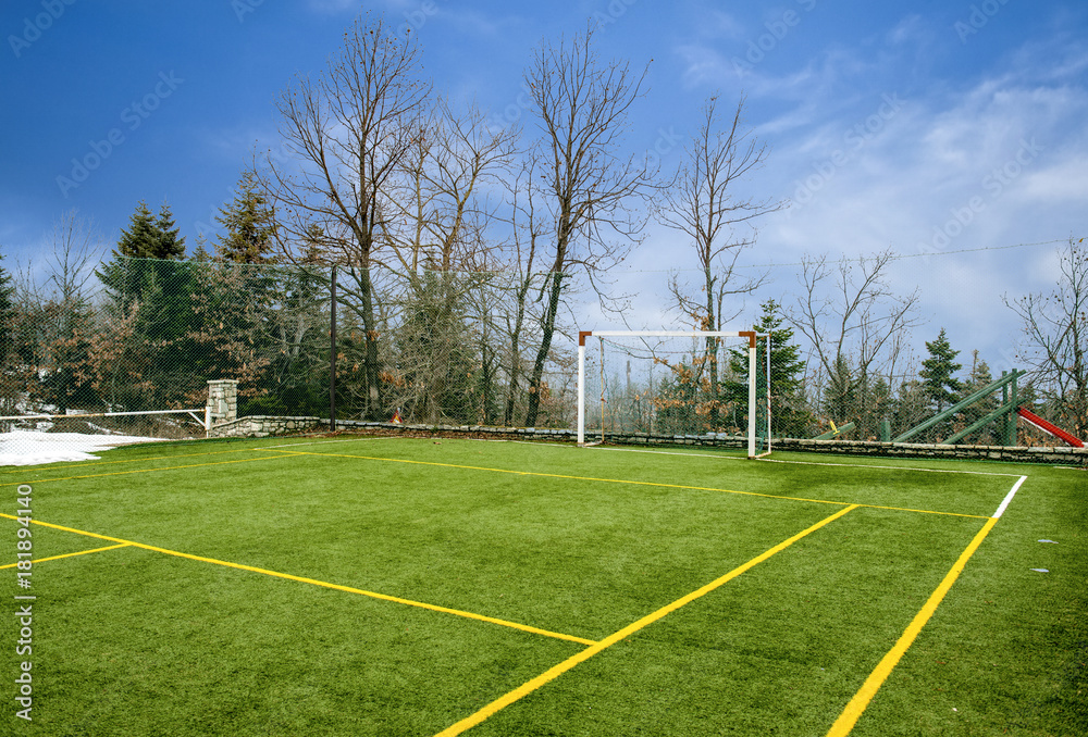 Obraz premium Field for soccer and other sports under blue sky with clouds at Winter