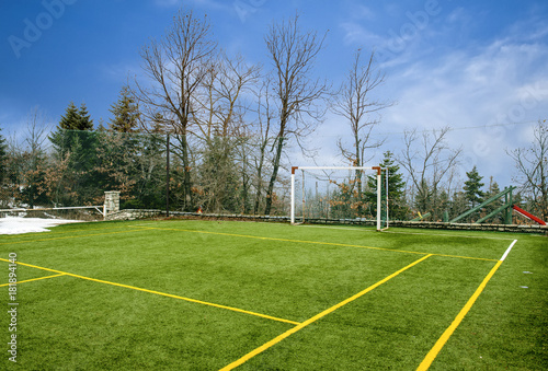 Field for soccer and other sports under blue sky with clouds at Winter