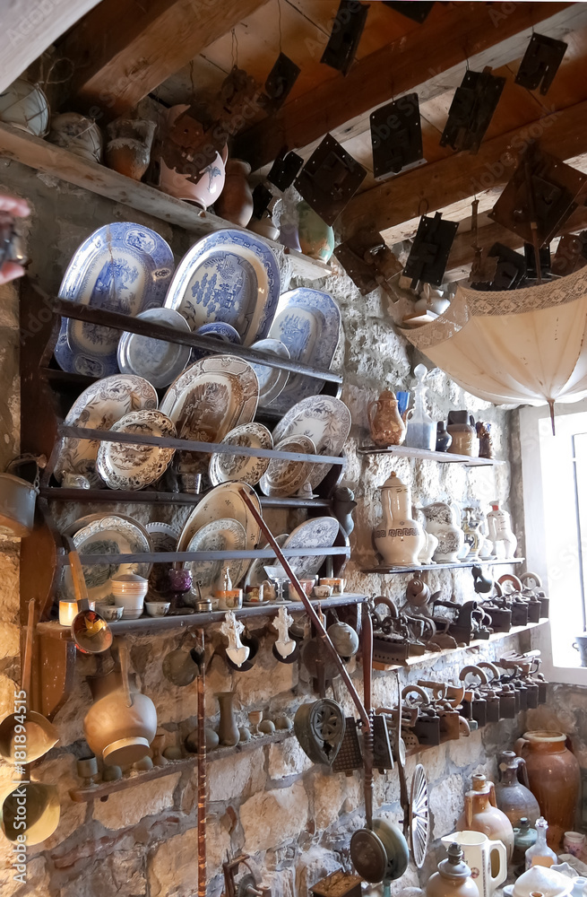 Variety of old household items on shelves collected in church as a gift, Montenegro. Variety of old household items on shelves collected in church as a gift, Montenegro.