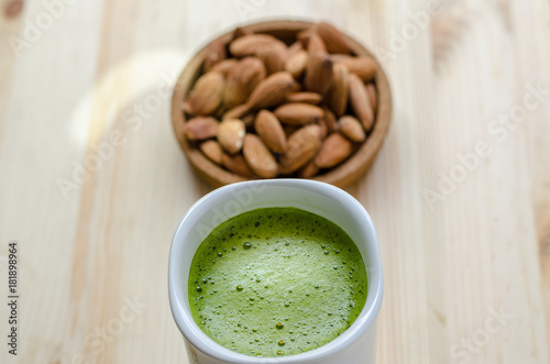 Hot green tea latte in lazy time with almonds nut
