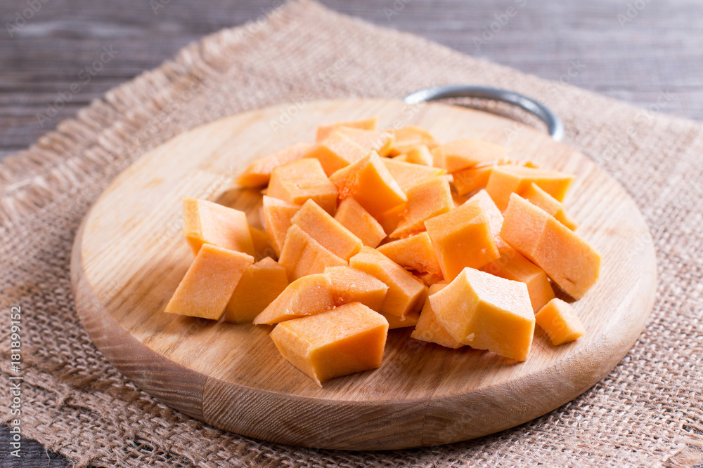 Pumpkin pieces on a cutting board Pumpkin pieces on a cutting board