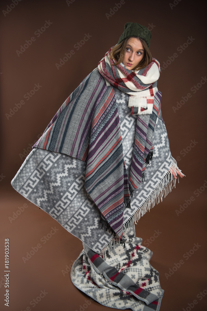 Girl standing wrapped in warm blankets