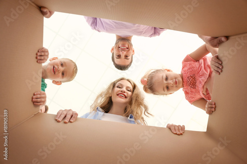 Happy family looking into c...