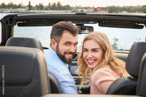 Happy young couple in car on river bank © Africa Studio
