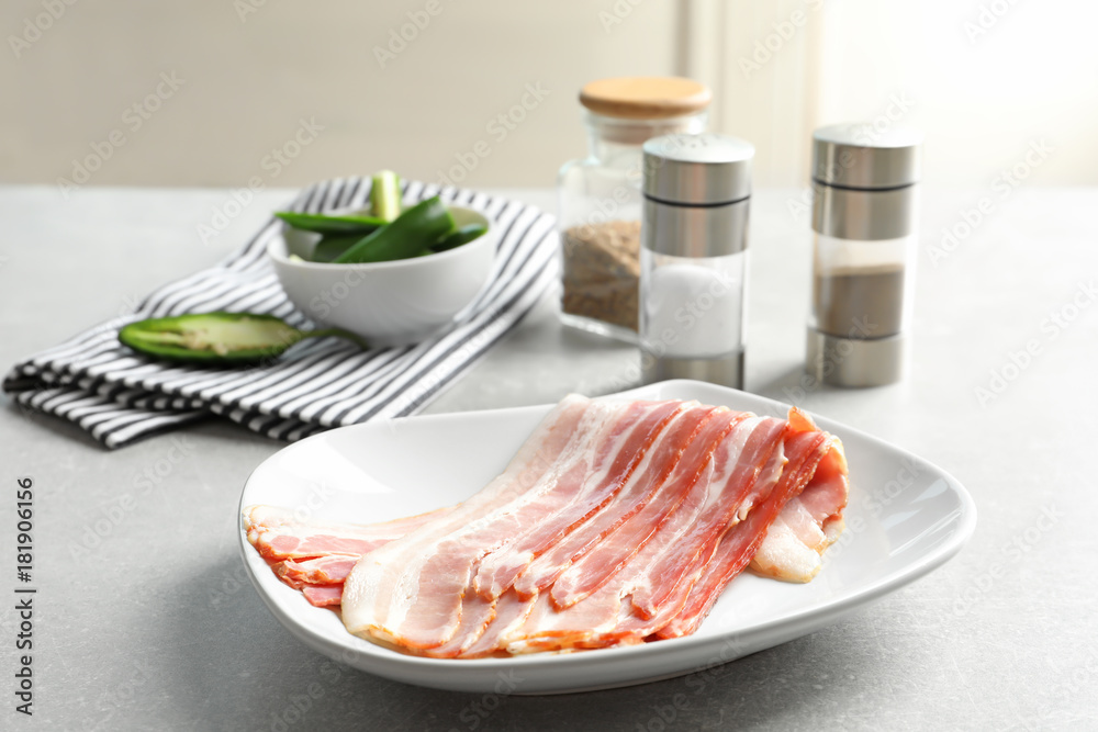 Plate with rashers of bacon on table Plate with rashers of bacon on table