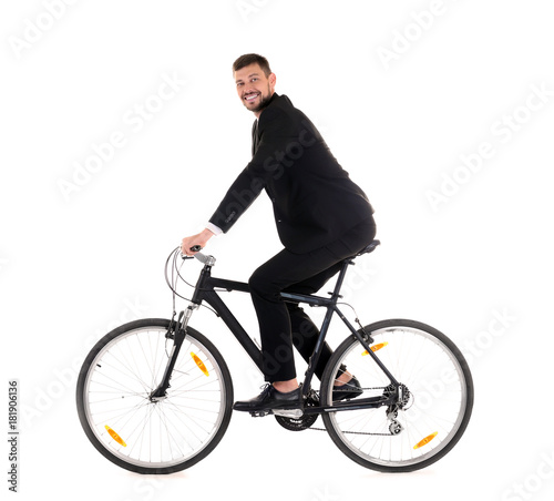 Handsome businessman riding bicycle on white background